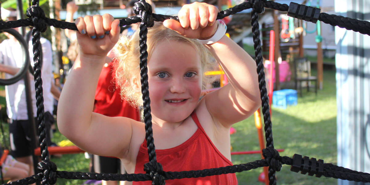 Make-A-Wish Australia wish kid Juniper climbing on her backyard ninja warrior obstacle course