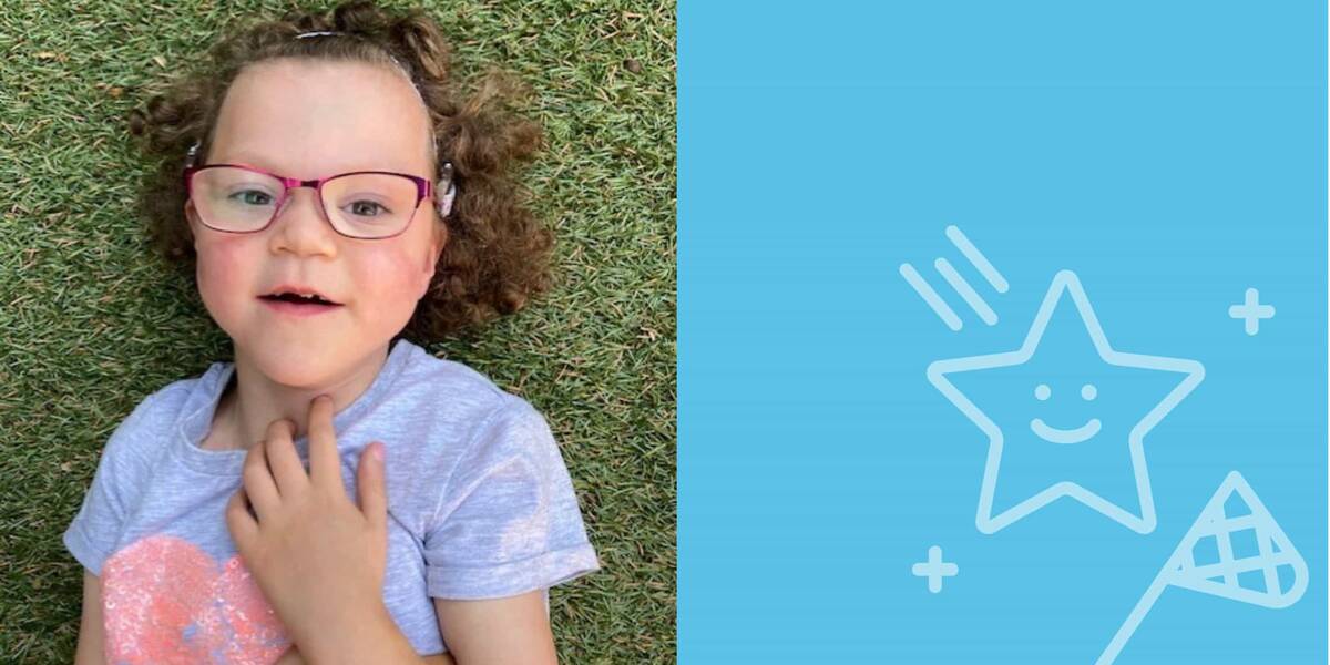 Make-A-Wish Australia wish kid Hannah lying on grass