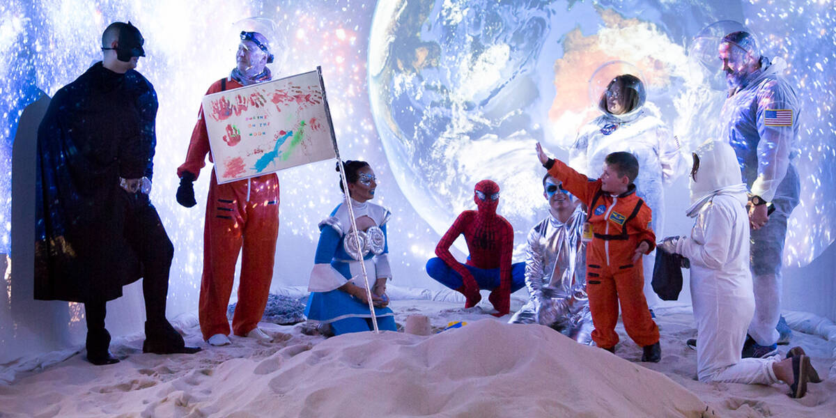 Make-A-Wish Australia wish kid Dwayne wearing his NASA spacesuit on the moon with other space characters