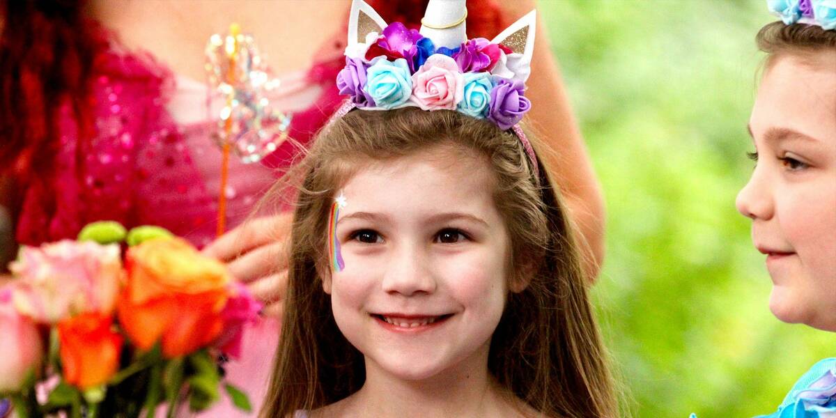 Make A Wish Australia Children's Charity - Abigial on he wish with a big smile her face and a unicorn headband