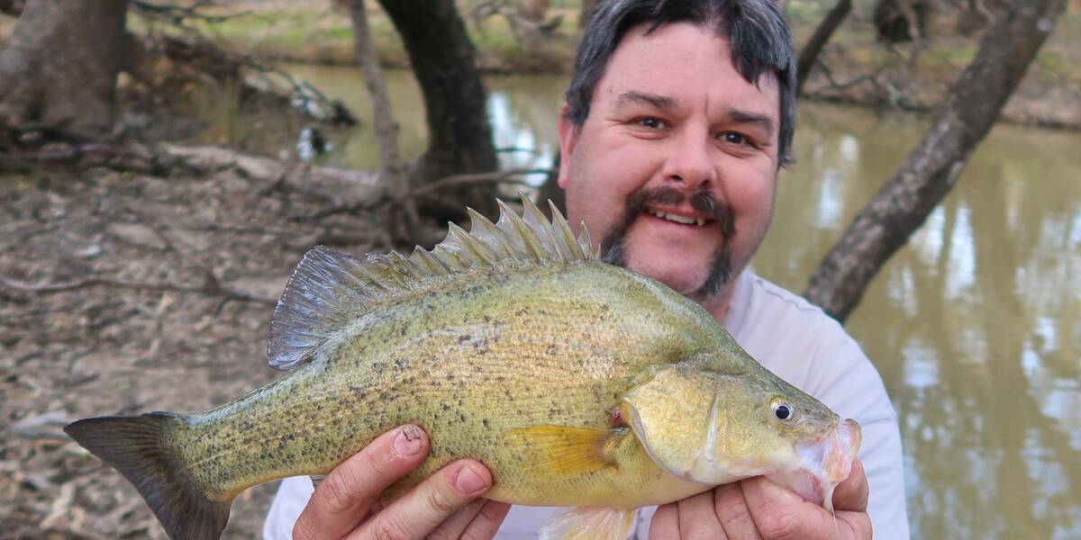 Make-A-Wish Australia volunteer Robbie holding a fish