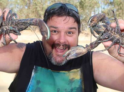 Make-A-Wish Australia volunteer Robbie holding up crayfish