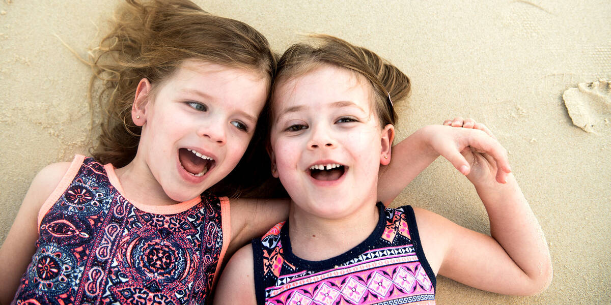 Make A Wish Australia Children's Charity - Audrey with her sister on the beach laughing