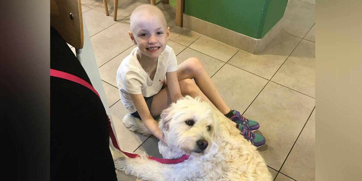 Make-A-Wish wish kid Scarlett with her dog