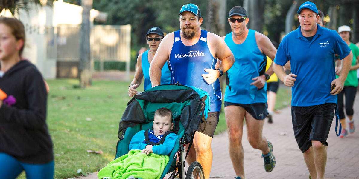 Make A Wish Australia Children's Charity - Aedan on his wish running with team wish and his dad