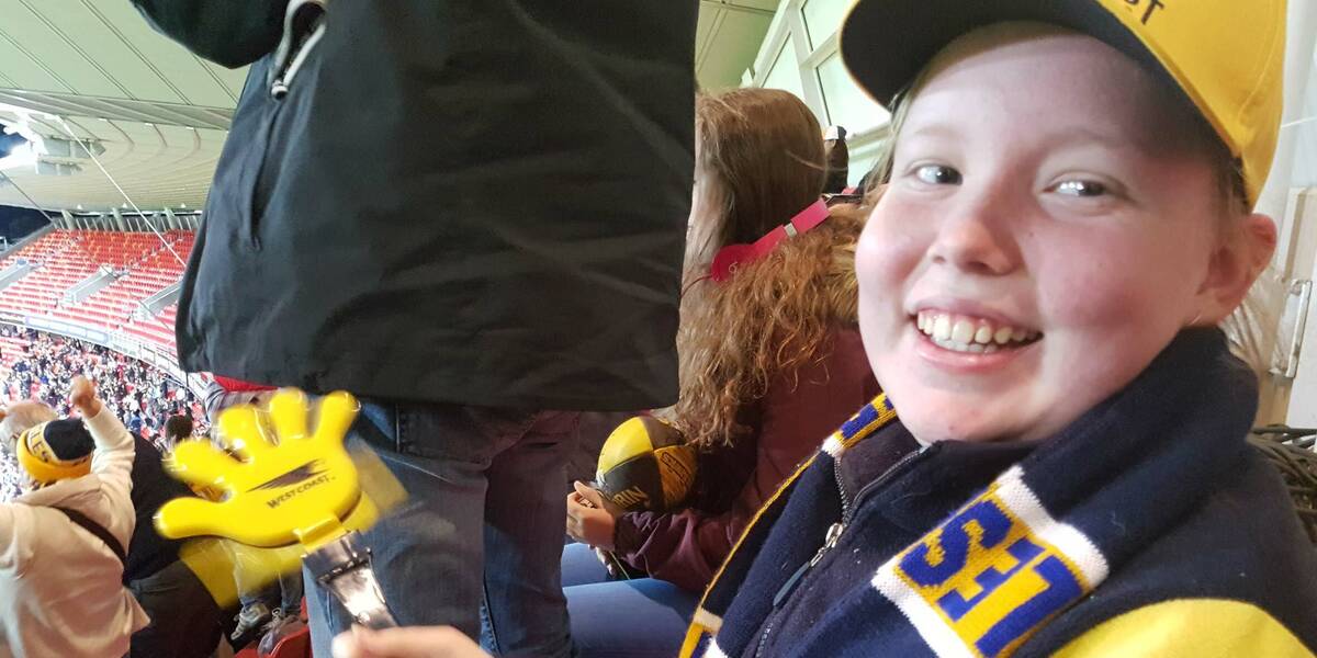 Make-A-Wish Australia wish kid Jacinta in her West Coast Eagles merch at a match