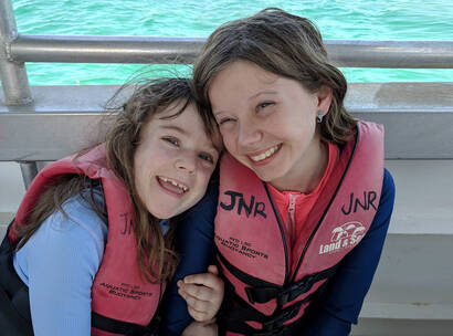 Make A Wish Australia Children's Charity - Freyja on her wish to meet the dugongs with her friend on a boat