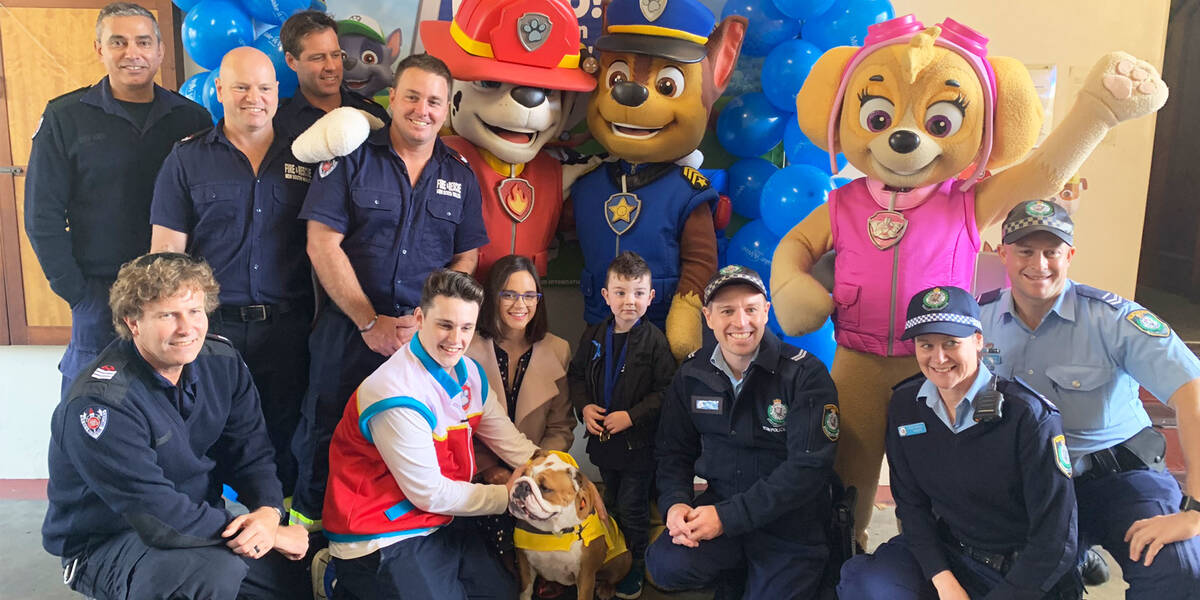 Make A Wish Australia Children's Charity, Rocco's wish standing with PAW patrol, Fire & Rescue NSW, the NSW Police Force