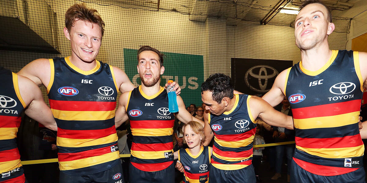 Make-A-Wish Australia wish kid Sullivan with the Adelaide Crows footy team in their room