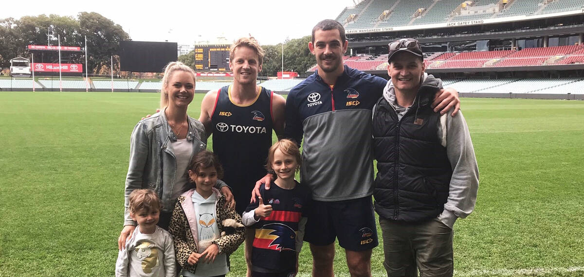 Make-A-Wish Australia wish kid Sullivan with Adelaide Crows footy players and family