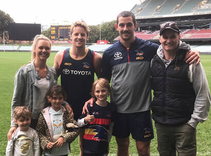 Make-A-Wish Australia wish kid Sullivan with Adelaide Crows footy players and family
