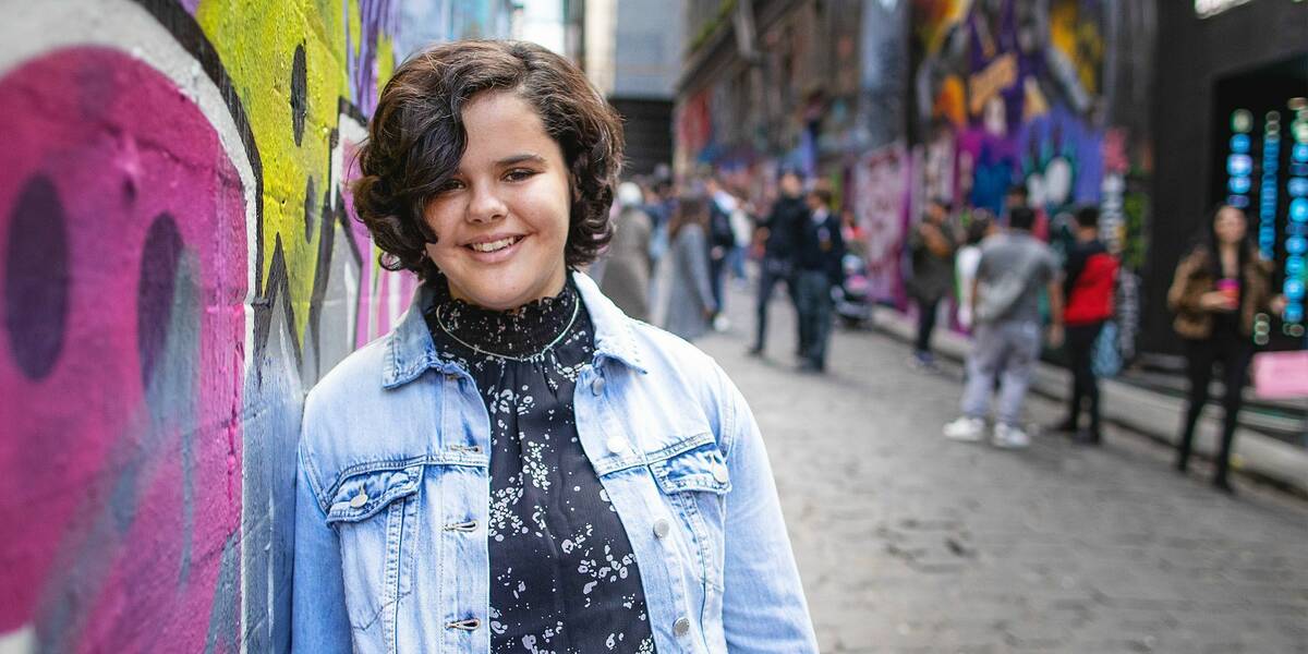 Make-A-Wish Australia wish kid Chelsea standing in Melbourne's Hosier Lane