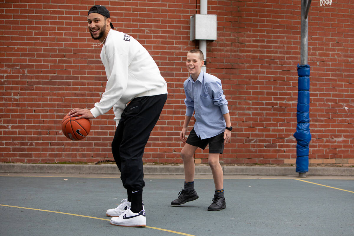 Make-A-Wish Australia wish kid playing basketball in the school yard with NBA star Ben Simmons