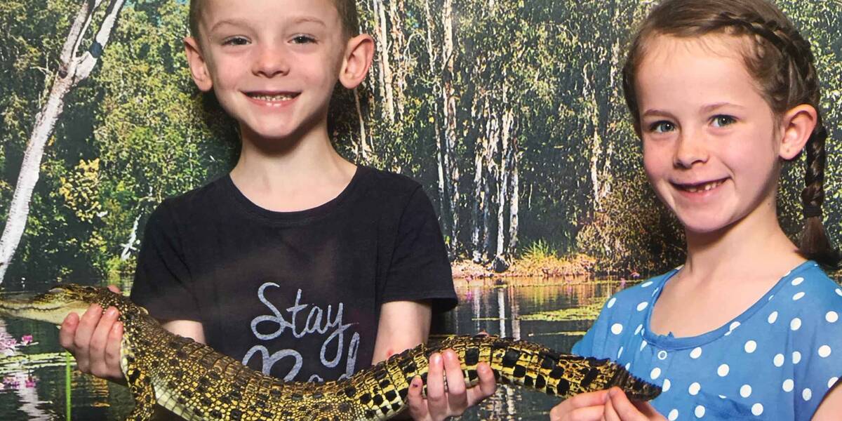 Make-A-Wish Australia wish kid Zak with sister holding a crocodile