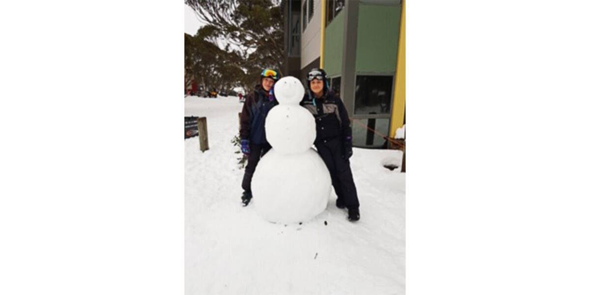 Harry with his family, dressed in warm clothes carrying skiing and snowboarding equipment