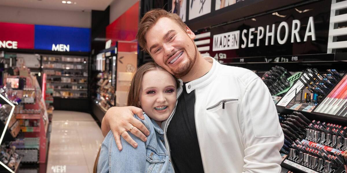 Make-A-Wish Australia wish kid Tylah hugging make up vlogger Michael Finch in Sephora