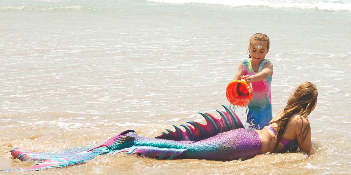 Make-A-Wish kid Jazmyn plays with a mermaid on the beach