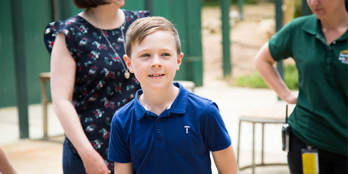 Make-A-Wish kid Henry, close up and smiling on his wish day to see animals