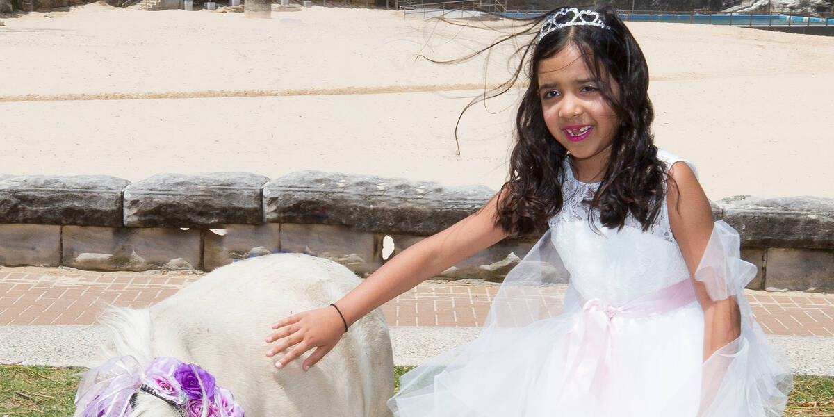 Make-A-Wish kid Priya meets a unicorn on her wish day.