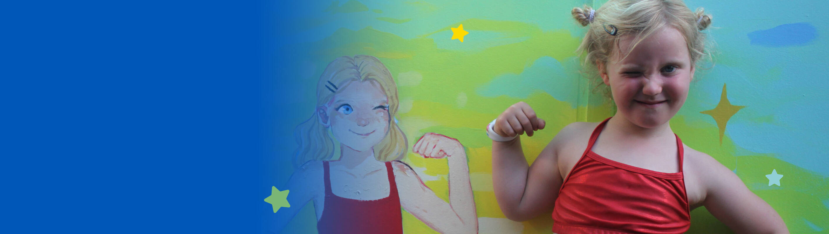 Make-A-Wish Australia wish kid Juniper in front of her ninja warrior inspired mural