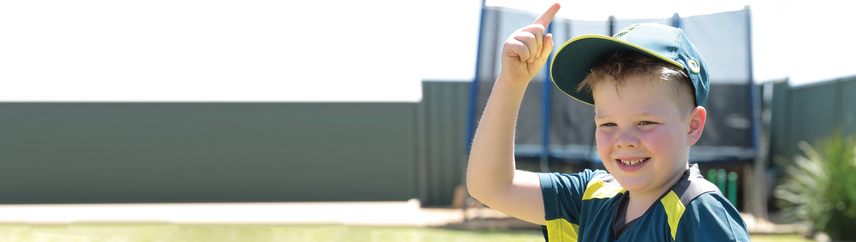 Make A Wish Australia, Children's Charity - Archie wearing a cricket outfit and smiling to camera