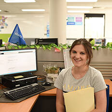 Make A Wish Australia Children's Charity - Office volunteer Courtney sitting at a desk